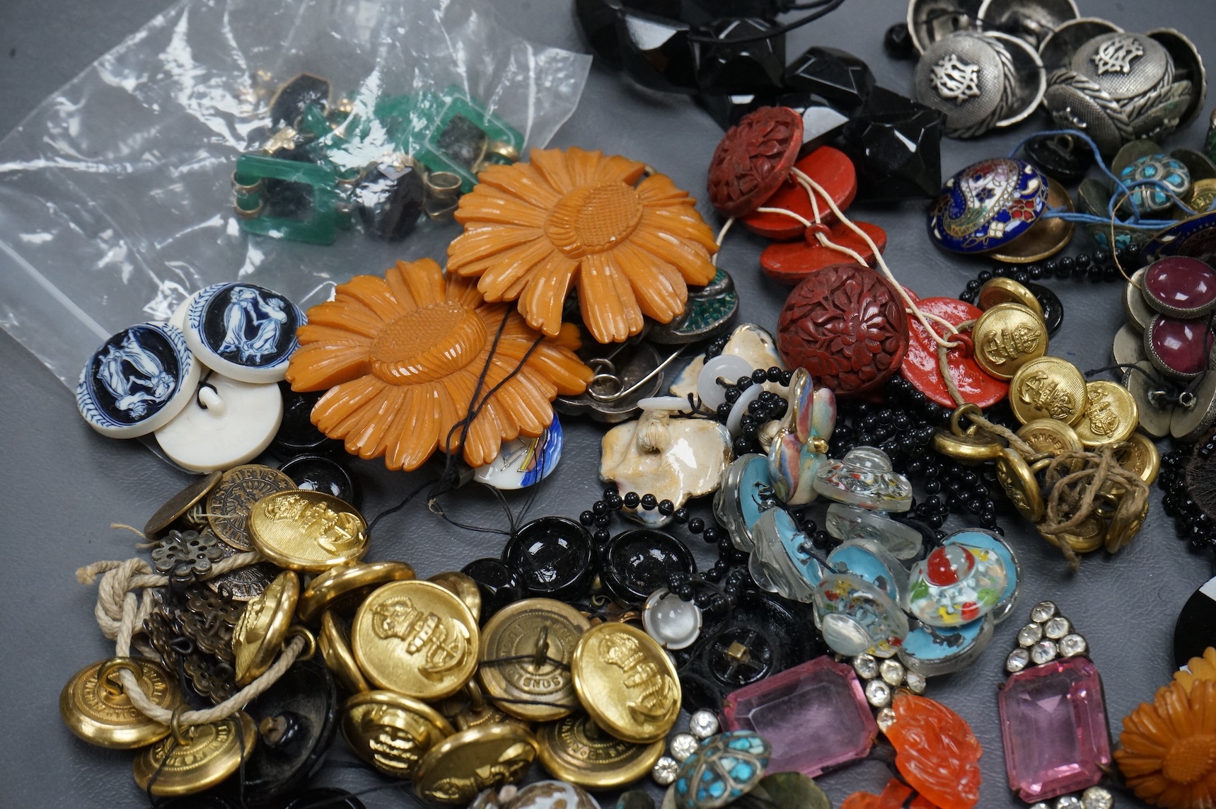 A collection of late 19th and 20th century buttons, some novelty, made from varying materials, metal, bakelite and glass.